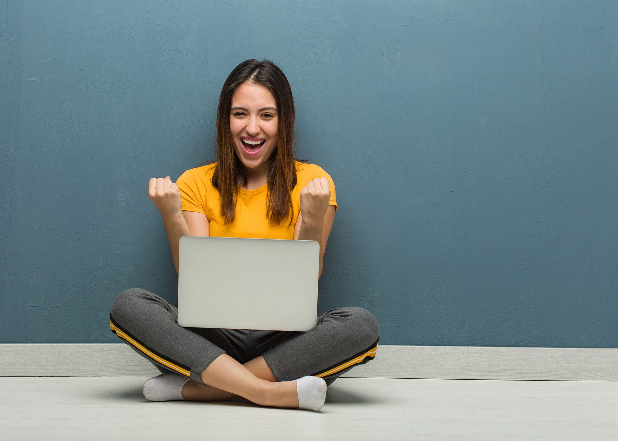Happy young woman with laptop